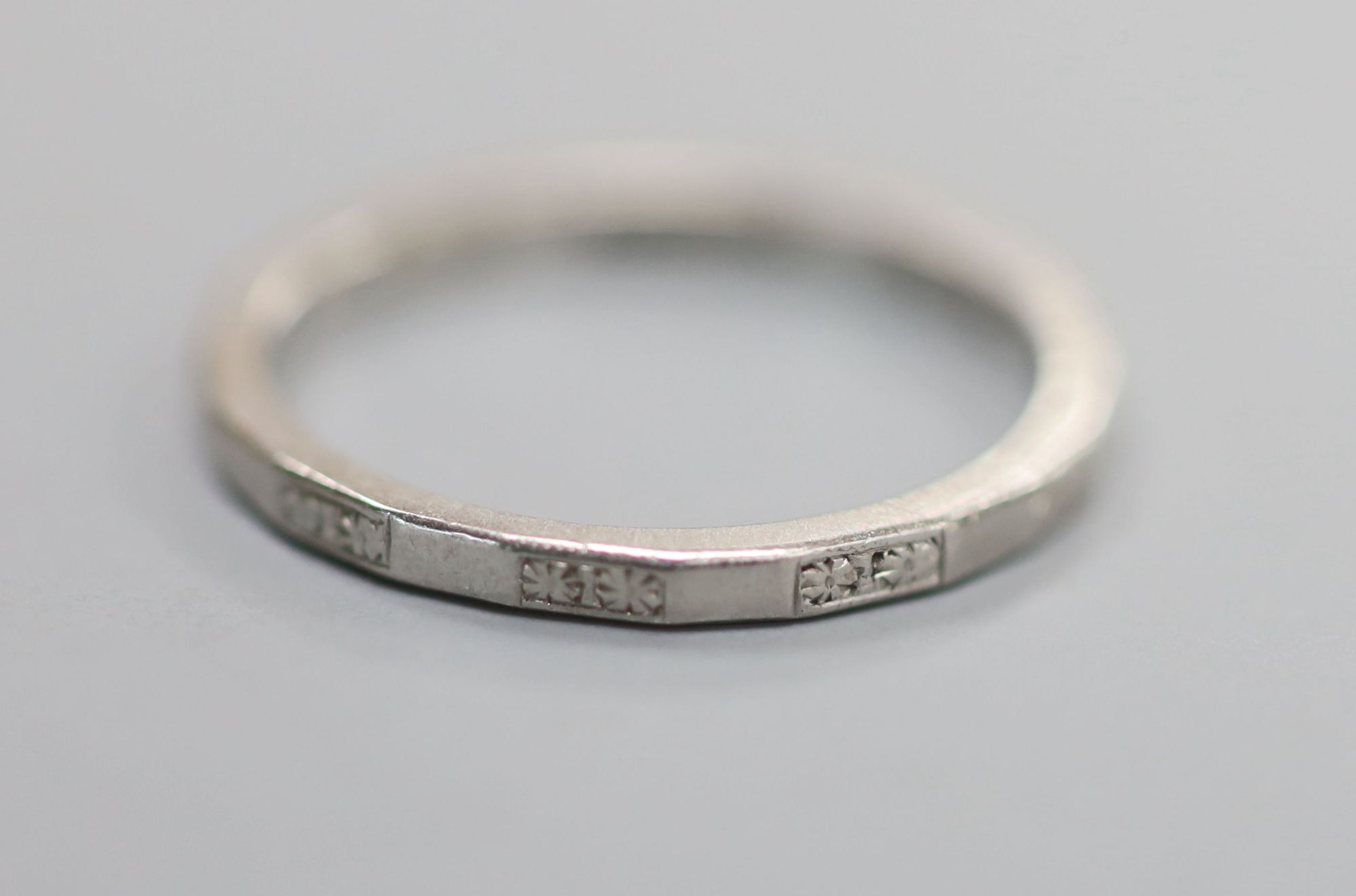 A shape white metal ( stamped platinum) wedding band, size M, 3.3 grams.